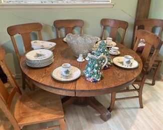 Round oak pedestal table with six chairs