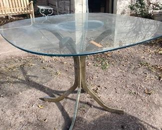 Glass-top table with brass bass