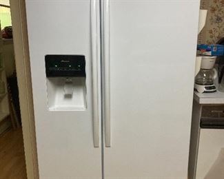 Amana side-by-side refrigerator freezer with in door amenities.