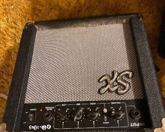 Amplifier in bedroom with guitars & sporting equipment