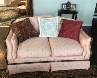 Rose color love seat with pillows 