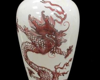 A CHINESE POTTERY BALUSTER VASE. PAINTED IRON RED AND BLACK UNDER GLAZE, OPPOSING IMPERIAL DRAGONS AND A PEARL OF WISDOM. 13" TALL