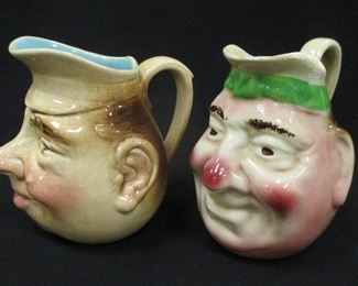 TWO ANTIQUE FRENCH MAJOLICA SARREGUEMINES CHARACTER JUGS. 5.25" TALL. REPAIR AND GLAZE NICKS ON THE RIM OF ONE