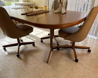 honey oak laminate vintage dining table with 2 leaves and vintage vinyl upholstered chairs
