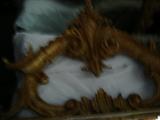 Showing the top of yet another gilded mirror.