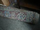 Room size rug rolled up.