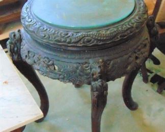 Carved table with glass top.