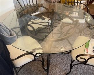 Wrought iron and glass table with 4 chairs.