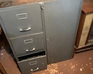 Three drawer file cabinet with attached cabinet. 