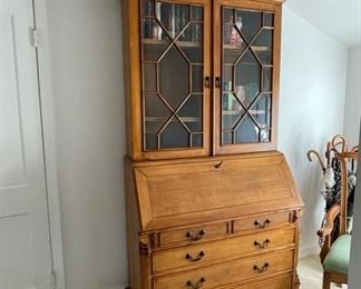 $1200  EXCEPTIONAL 5 DRAWER SECRETARY DESK W/DROP DOWN WRITING SURFACE & UPPER STORAGE
WHY WE LOVE IT:
The upper bookcase section has two shelves with a paned glass front for display and extra storage.  The lower secretary section has drop front writing surface with a carved wood writing panel, several small mail slots and storage areas.. Pull-out slides support the writing surface. The base consists of 5 ample sized drawers for incredible hidden storage.  The entire united is crowned with a modified dentil molding.  Pine colored stain for a lighter finish.
DETAILS + DIMENSIONS:
41W X 20 D X 87H
CONDITION: This is a vintage piece that has been well cared for and is in very good condition with only minor signs of wear to be expected with use and age.  Please refer to photos for a more detailed look at condition.  We make every attempt to list and photograph any defects or signs of wear that are significant to this sale. 
LOCAL PICK UP ALEXANDRIA, VA.  BUYER IS RESPONSIBLE FOR ANY NECESS