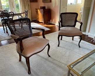 $600   PAIR OF VINTAGE FRENCH CANE BACK ARM CHAIRS LOUIS XV 

 WHY WE LOVE THEM:

This beautiful pair have seat backs that are caned resting on horseshoe shaped seats that are covered in a light pink velvet secured with a silk corded pipe.  Simple serpentine skirts flow into restrained cabriole legs.  Truly an elegant set of chairs that add elegance and sophistication to any room.

 DETAILS + DIMENSIONS:

 33H X 24W X 18D inches
 
CONDITION: These are vintage pieces that have been extremely well cared for and are in very good condition.  There may be minor superficial signs of wear to be expected with use and age. Please refer to photos for a more detailed look at condition.  We make every attempt to list and photograph any defects or signs of wear that are significant to this sale. 

 

LOCAL PICK UP ALEXANDRIA, VA.  BUYER IS RESPONSIBLE FOR ANY NECESSARY DISASSEMBLY AND ALL COSTS ASSOCIATED WITH SHIPPING OR PICK UP.  CONTACT US FOR SHIPPING RECOMMENDATIONS.
