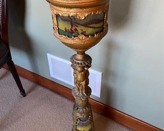 Antique floor ashtray with painted glass features.