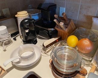 Kitchen with much quality cookware/dinnerware.