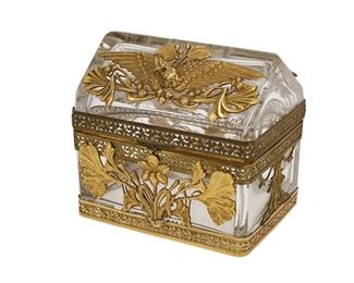 1004
A French Crystal And Gilt-Bronze Jewelry Box
Fourth-Quarter 19th Century
Possibly Baccarat, the crystal jewelry box with Art Nouveau-style foliate gilt-bronze mounts and two Empire-style eagles with glass eyes to the hinged lid
4.75" H x 5.25" W x 4" D
Estimate: $800 - $1,000