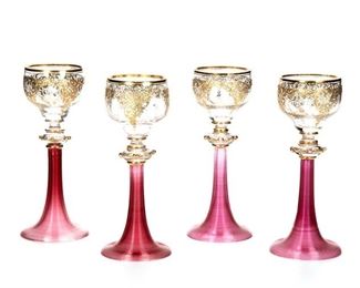 1011
A Set Of Venetian Murano Glass Goblets
First-Half 20th Century
Each goblet with a clear glass bowl decorated with gilt enamel highlights and raised on a pink, trumpet-form, threaded stem, 14 pieces
Each: 8" H x 3.25" Dia.
Estimate: $800 - $1,200