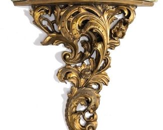 1033
A Carved Giltwood Wall-Mounted Console Table
20th Century
The wall-mounted console table with a demi-circle green marble top over a scrolling rocaille carved giltwood base
37" H x 33" W x 9.75" D
Estimate: $800 - $1,200