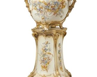 1037
A German Jugendstil Porcelain Jardinière With Stand
Late 19th/Early 20th Century
Planter marked for Royal Bonn and numbered: 976 / 32 / 3114
Each Art Nouveau-style with gilt rocaille motifs centering polychrome and gilt enamel floral sprays, comprising a handled jardinere on a flared pedestal stand, 2 pieces
Planter: 16.5" H x 21" W x 16" D; Stand: 24" H x 14.5" W x 14.5" D
Estimate: $800 - $1,200