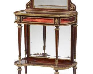 1043
A French Louis XVI-Style Table Vitrine
Fourth-Quarter 19th Century
The metal-mounted vitrine surmounted by a mirrored back panel with a wreath crest over a hinged, inset glass panel top cabinet with velvet interior, supported on four tapered legs joined by an undershelf with a mirrored back panel, all raised on four pole feet
43.5" H x 27.75" W x 16" D
Estimate: $3,000 - $5,000