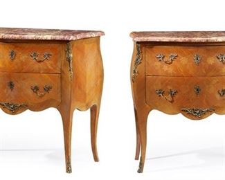 1051
A Pair Of Louis XV-Style Commodes
20th Century
Each commode with marble top over two long drawers with floral marquetry veneer and gilt-bronze mounts raised on slightly outswept legs with sabots to the feet, 2 pieces
Each: 33" H x 34.25" W x 16.5" D
Estimate: $1,200 - $1,800
