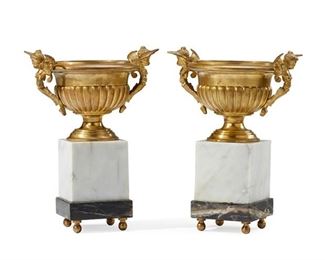1058
A Pair Of Gilt-Bronze And Marble Garniture Urns
20th Century
Each a gilt-bronze urn flanked by opposed figural handles over a white marble columnar plinth atop a brown variegated marble base raised on four ball feet, 2 pieces
Each: 16.5" H x 12" W x 8.75" D
Estimate: $1,000 - $2,000
