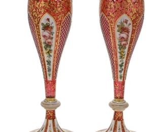 1063
A Pair Of Bohemian Art Glass Vases
Fourth-Quarter 19th Century
Each tapering vase acid-cut from opaque white to translucent cranberry glass decorated with panels of polychrome floral sprays alternating with diamond-cut panels against a field of gilt highlights, 2 pieces
Each: 13.25" H x 3.5" Dia.
Estimate: $1,500 - $2,500