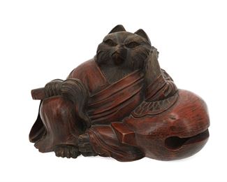 1081
A Japanese Carved Wood Fox Sculpture
First-Quarter 20th Century
Signed to verso
The carved and polychromed wood sculpture depicting a seated and robed fox
8" H x 13.5" W x 8" D
Estimate: $600 - $900
