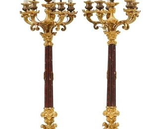 1092
A Pair Of Gilt-Bronze And Marble Candle Lamps
20th Century
Each six-light, gilt-bronze candelabrum with a red marble column issuing five scrolled arms and one central light with faux candle sleeves raised on a tri-form base, electrified, 2 pieces
Each: 35" H x 10.5" Dia.
Estimate: $3,000 - $5,000