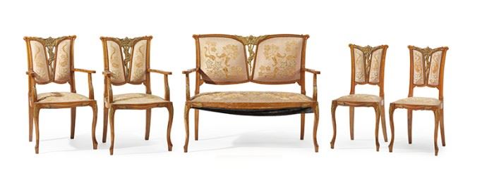 1104
An Art Nouveau Settee Set
First-Quarter 20th Century
Each with a carved wood frame with Art Nouveau floral motifs, an openwork back splat, and floral embroidered velvet upholstery with nail head trim, comprising a settee, two armchairs, and two side chairs, 5 pieces
Settee: 38.25" H x 44" W x 22" D; Each armchair: 38.25" H x 21.5" W x 22" D; Each side chair: 35.5" H x 16.5" W x 18" D
Estimate: $6,000 - $8,000