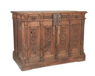 1109
A Continental Carved Oak Coffer
17th/18th Century
The carved oak coffer with a rectangular hinged lid atop a frieze of rosettes and two drawers with metal drop handles over four front panels with portrait roundels and foliate garlands, partitioned by coin and foliate moldings and four side panels with linenfold parchemin plisse carvings, centering an openwork filigree lock plate with portrait heads, raised overall on a pedestal base
35" H x 47.5" W x 26" D
Estimate: $500 - $1,000