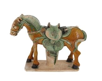 1114
A Chinese Sancai Glazed Ceramic Horse
Circa 15th/16th Century, Ming Period (1368-1643)
The ceramic horse figure with sancai green and amber glaze standing atop an unglazed integral plinth
9" H x 12.5" W x 4" D
Estimate: $2,500 - $3,500