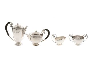 1137
A Georg Jensen Sterling Silver Tea And Coffee Service
Mid-20th Century
Each marked: Georg Jensen / Sterling / Denmark; Further numbered: 321 A
Each with a hammered body, scrolled handles, and a stepped foot, comprising a coffee pot with wood handle (8.25" H), a teapot with wood handle (5.75" H), a sugar bowl (4.125" H), and a creamer (4" H), 4 pieces
56.04 gross oz. troy approximately
Estimate: $2,500 - $3,500