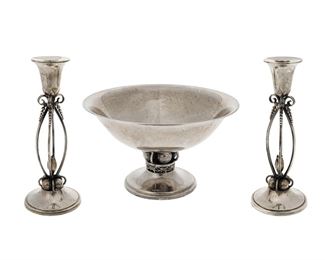 1138
A Group Of Georg Jensen-Style Sterling Silver Table Items
20th Century
Each marked: Sterling / [B or 3]; Further marked: 33 / 81
Each with foral motifs and applied ball designs, comprising a compote (6" H x 10.25" Dia.) and two matching candlesticks (10.25" H x 4.125" Dia.), 3 pieces
48.115 oz. troy approximately
Estimate: $700 - $900