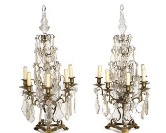 1159
A Pair Of Gilt-Bronze Girandoles
First-Quarter 20th Century
Each flat-backed girandole suspending clear glass pendalogue drops and issuing five scrolled arms with faux-candle sleeves raised on a gilt-bronze tripod base, electrified, 2 pieces
Each: 35" H x 16.5" W x 10" D
Estimate: $1,000 - $1,500