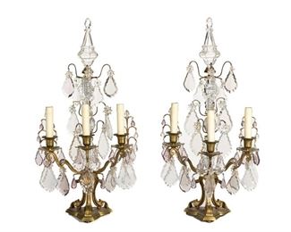 1160
A Pair Of Gilt-Bronze Girandoles
First-Quarter 20th Century
Each flat-backed girandole suspending clear and translucent purple glass pendalogue drops and issuing three scrolled arms with faux-candle sleeves raised on a gilt-bronze tripod base, electrified, 2 pieces
Each: 27" Hx 14" W x 10" D
Estimate: $800 - $1,200
