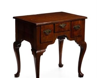 1170
An English Queen Anne-Style Lowboy
Mid-18th Century
The lowboy with walnut burl veneer and oak construction, the rectangular top over three drawers with brass pulls atop a shaped apron raised on four cabriole bracket legs
26.75" H x 26.125" W x 18.125" D
Estimate: $1,000 - $2,000