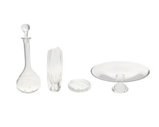 1191
A Group Of Baccarat Crystal Items
20th Century
Each etched: Baccarat / France
Comprising a "Pavot" decanter (14.75" H x 5" Dia.), a "Wave" coaster (0.75" H x 5.25" Dia.), a "Giverny" bud vase (9.875" H x 3" W x 3.25" D), and a pedestal cake stand (5.125" H x 13.125" Dia.), 4 pieces
Estimate: $400 - $600