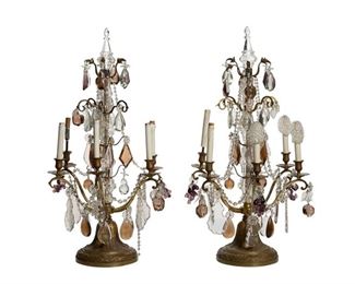 1196
A Pair Of Gilt-Bronze Girandoles
First-Quarter 20th Century
Each flat-backed girandole suspending clear glass pendalogue drops, translucent purple glass fruit-shaped drops, and chains issuing five arms with faux-candle sleeves raised on a gilt-bronze pedestal base, electrified, 2 pieces
Each: 36" H x 18" W x 13" D
Estimate: $1,500 - $2,500