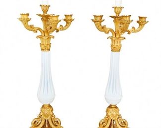 1199
A Pair Of French Gilt-Bronze And Opaline Glass Candle Lamps
First-Quarter 20th Century
Each gilt-bronze lamp with a tapered and ribbed opaline column raised on three scrolled foliate feet atop a tri-form stepped pedestal base with egg and dart border and issuing five candle arms with a central standard terminating in two electrical light sockets with pull chains, electrified, 2 pieces
Each: 29" H x 9.5" Dia.
Estimate: $1,200 - $1,800
