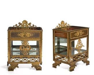 1203
A Pair Of Gilt-Bronze Glazed Bedside Tables
First-Quarter 20th Century
Each with a rocaille motif openwork back panel atop a rectangular inset glass top over a drawer and single-door glazed cabinet with mirrored interior raised on four rocaille feet, 2 pieces
Each: 27.5" H x 21" W x 13.5" D
Estimate: $2,000 - $3,000