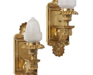 1233
A Pair Of Gilt-Bronze Sconces
First-Quarter 20th Century
Each wall sconce with a rectangular back plate with rocaille motifs issuing a scrolled foliate arm and a single light with a foliate socket fitted with a contemporary frosted glass shade, electrified, 2 pieces
Each: 18" H x 6" W x 9.5" D
Estimate: $500 - $700