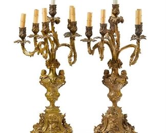1238
A Pair Of Gilt-Bronze Candle Lamps
Late 19th/Early 20th Century
Each six-light gilt-bronze candelabrum with a foliate column issuing six arms terminating in foliate-style capitals with faux candle sleeves and raised on a footed base with putti masks, electrified, 2 pieces
Each: 31.5" H x 15" W x 14" D approximately
Estimate: $2,000 - $3,000