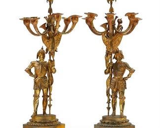 1243
A Pair Of Gilt-Bronze Candelabra
Late 19th/Early 20th Century
Each armorial theme, gilt-bronze figural candelabrum in the form of an armored knight bearing a standard with flags and weapons issuing five arms and raised on a hexagonal base, 2 pieces
Each: 25.5" H x 11.25" W x 9" D approximately
Estimate: $2,000 - $3,000