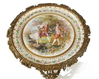 1245
A Sèvres Porcelain And Gilt-Bronze Side Table
Late 19th/early 20th Century
Sèvres mark to base; Illustration signed: LeBrun
Centering a platter enclosed in gilt-bronze mounts raised on a white porcelain pedestal on a scrolled gilt-bronze base
31.25" H x 20" Dia.
Estimate: $2,500 - $3,500