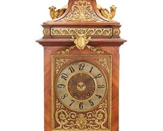 1252
A French Gilt-Bronze Mounted Wood Mantel Clock
Second-Half 19th Century
Movement signed: Vincenti et Cie / Medaille d'Argent / 1855 / 1089 / 9 2
The clock with a brass dial with black Arabic numeral hour markers and black openwork hands set in a bookmatch parquetry veneered wood case with anthemion trim and scrolling acanthus leaf motifs, flanked by two low relief figural panels, centering a cartouche, and surmounted by a wavescroll frieze, two opposed griffins, and urn-form finial with figural masks, raised overall on four bracket feet
30" H x 15.25" W x 11.875" D
Estimate: $2,500 - $3,500