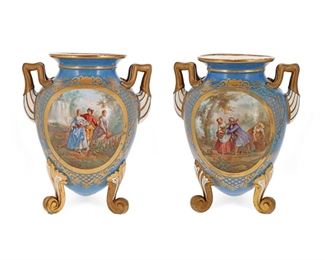 1253
A Pair Of Sèvres-Style Porcelain Urns
Late 19th/Early 20th Century
Each tripod urn centering pastoral courting scenes surrounded by gilt highlights on a light blue ground flanked by squared handles and raised on three scrolled feet, 2 pieces
Each: 16" H x 12" W x 10" D
Estimate: $1,000 - $1,500