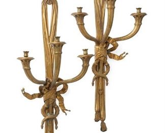 1263
A Pair Of Gilt-Bronze Wall Scones
Late 19th/Early 20th Century
Each gilt-bronze wall sconce in a stylized drapery-form designed as a hanging tassel joined by a tied ribbon and issuing three reeded arms terminating in fluted bobeches, electrified, 2 pieces
Each: 39" H x 17.25" W x 9" D
Estimate: $1,000 - $1,500
