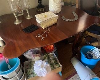 Antique double sided folding card table with a wooden table top on one side and leather card game top on the other. Lovely floral carving on the legs. Foods in half a d can be used in hallway or entry way. Lovely for extra seating! 