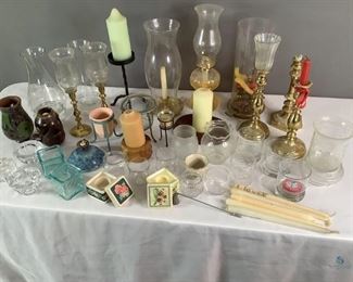 Brass, Glass, Ceramic Candle Sticks
Numerous candlesticks and candle holders of various sizes. Some brass, glass, ceramic, colored. Includes oil lamps, candles, hurricane lamps, candle snuffer. All in fairly good condition, some have melted candle wax, but no visible damage seen.