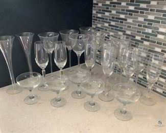 Champagne Glasses
Several different styles of champagne glasses. Some are tall stemmed, others are fluted or short stemmed. All are matching in pairs or sets, some sets are incomplete. No visible damage seen. Dusty from storage.
