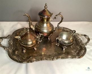Wm Rogers Silver Plated Tea Set
Set includes covered teapot, covered creamer, sugar bowl and serving tray. All pieces are stamped with W M Rogers on the bottom. All pieces show tarnishing. Tray is 24". Tea pot is 10"H.